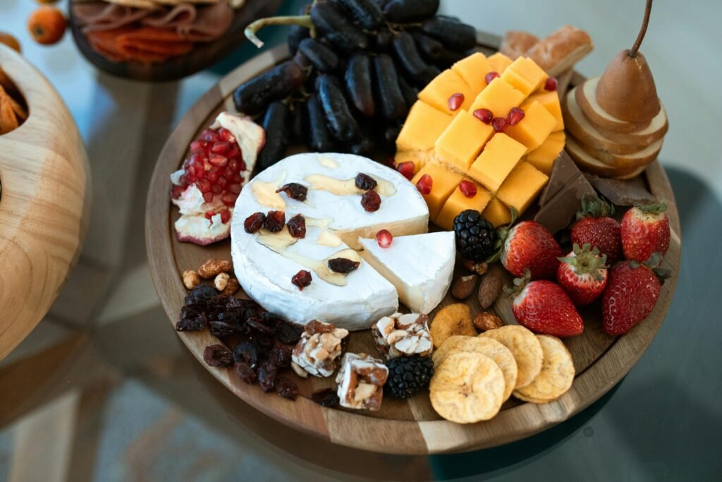 Elegant charcuterie board with cheese, fruits, and nuts, perfect for entertaining.